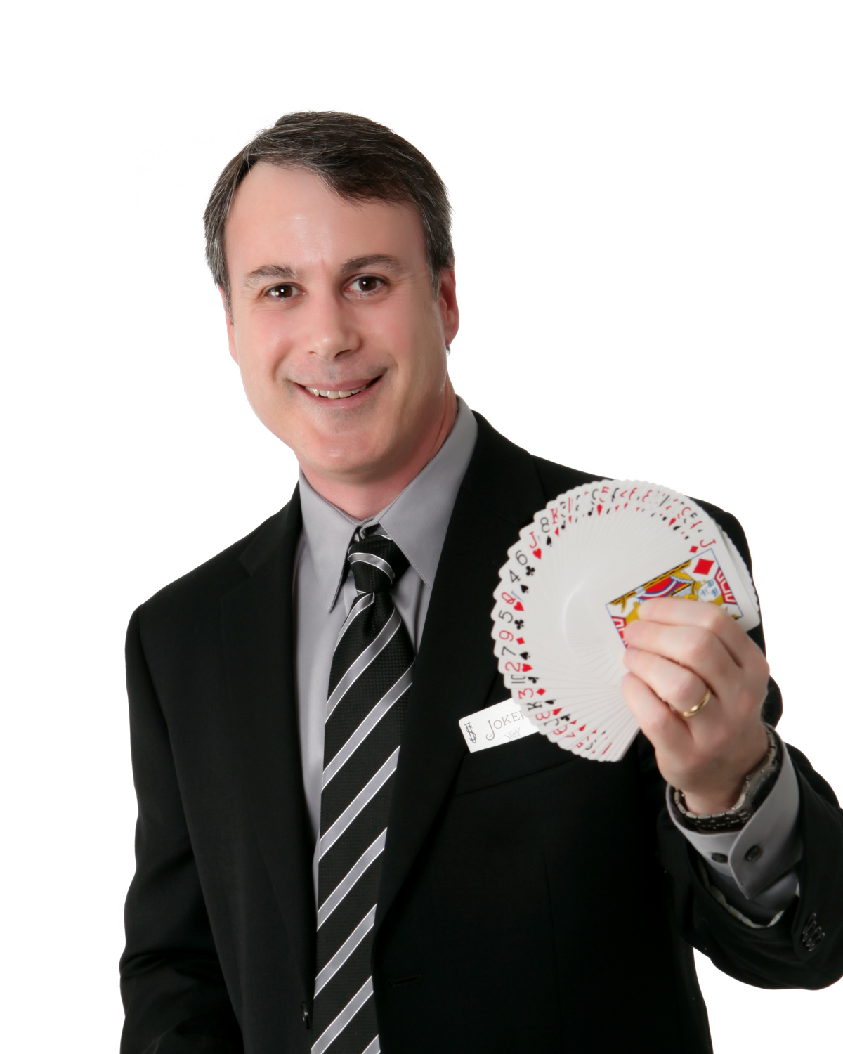 Rick Hebert, Houston magician and mentalist, in a black suit fanning a deck of cards